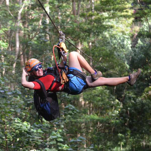 kickinbacksquare a person enjoying ziplining