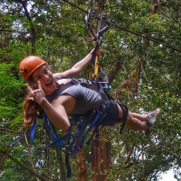 a girl ziplining in hawaii Zip Aerobatics - The Coffee Table