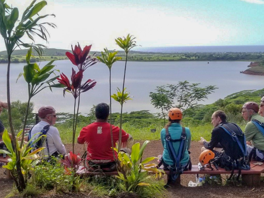 playground-waita a group of people sitting on the side of a river