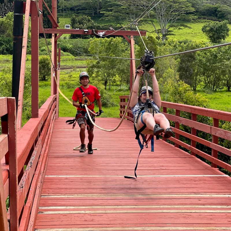 a group of people riding on top of a wooden fence